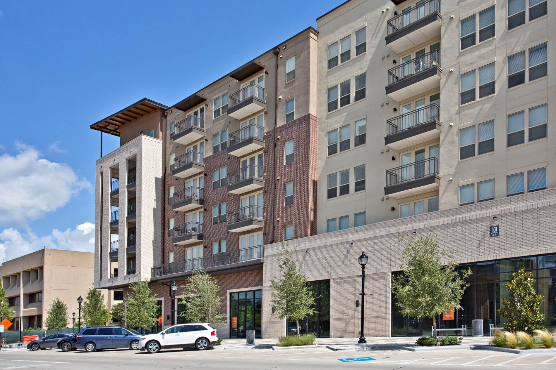 A modern, multi-story residential complex representing the high-end locations where Wellness On Demand provides mobile IV hydration services directly to your door